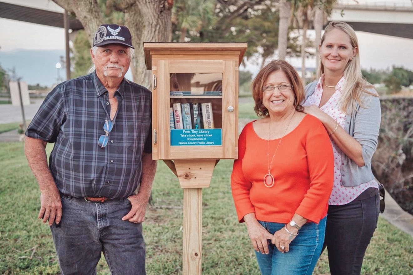 MOORE HAVEN — Pictured left to right, Tim Smith, Sandy Lundy and Sommer Foster stand next to the first Glades County “The Tiny Library.”